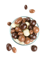 chocolate covered nuts and raisins isolated on white