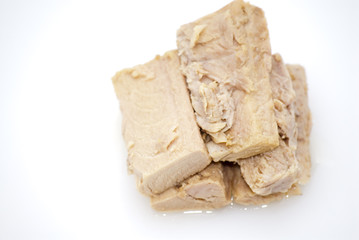 Group of pieces of tuna in olive oil