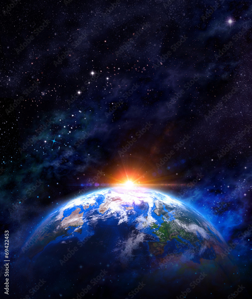 Wall mural sunrise over earth in outer space
