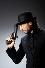 Fototapeta na wymiar Man with gun and vintage hat