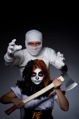 Halloween concept with mummy and woman with axe