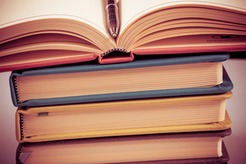 Close-up of open book and pen