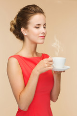 smiling woman in red dress with cup of coffee