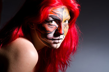 Woman with tiger face in halloween concept