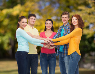 group of smiling teenagers over green park