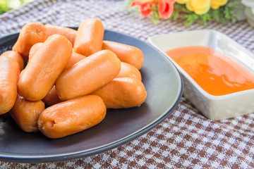 sausages and sauce on table