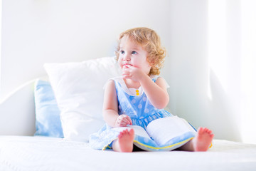 Little cute girl reading a book