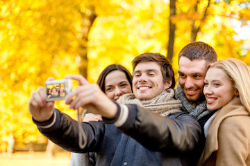 group of smiling men and women making selfie