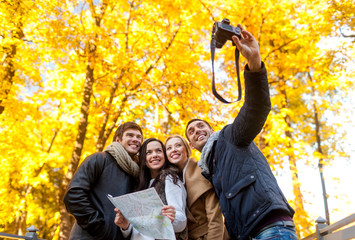 group of friends with map outdoors