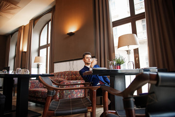 Successful businessman sitting at the table of the restaurant