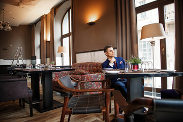 Successful businessman sitting at the table of the restaurant