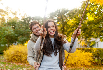 smiling couple hugging in autumn park