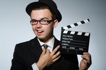 Man with movie clapperboard and hat