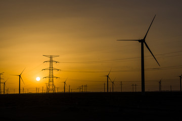 sunset over a windfarm