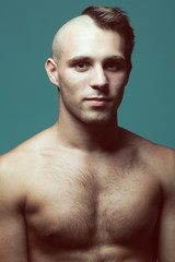 Fototapeta premium Male beauty concept. Handsome male model with half-shaved head