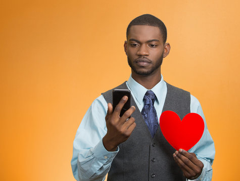 man reading news text message on his smartphone, holding heart