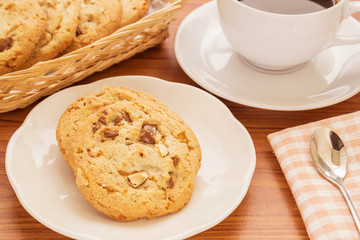 Chocolate chip cookie with almond and coffee cup, Filtered image