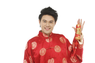 young man with tradition clothing holding lucky Symbol posing