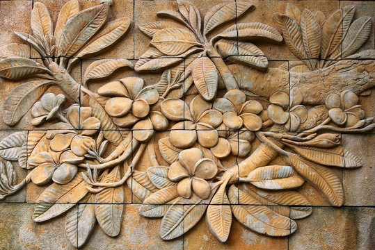 Low relief cement Thai style handcraft of plumeria or frangipani