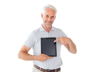 Smiling man pointing to his tablet pc