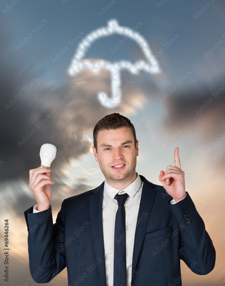 Poster composite image of businessman holding light bulb and pointing