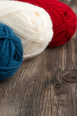 Balls of wool wooden background