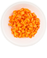 Chopped carrot in a bowl over white background