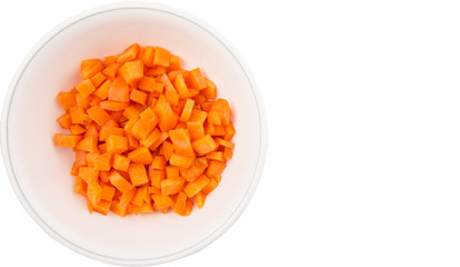 Chopped carrot in a bowl over white background