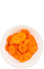 Chopped carrot in a bowl over white background