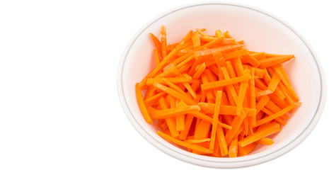 Chopped carrot in a bowl over white background