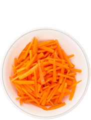 Chopped carrot in a bowl over white background