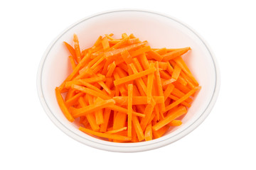 Chopped carrot in a bowl over white background