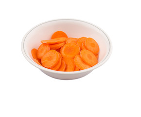 Chopped carrot in a bowl over white background