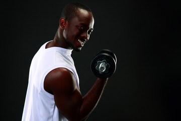 Fototapeta na wymiar handsome african sports man over black background