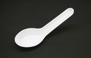 white spoons soup on black
