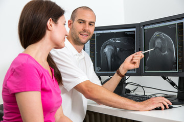 Radiologist councelling a patient using MRI images
