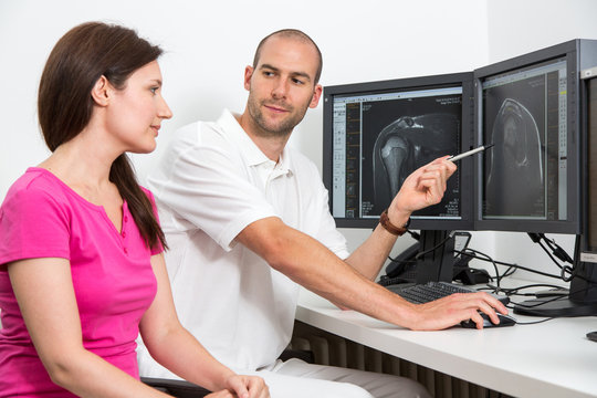 Radiologist councelling a patient using MRI images