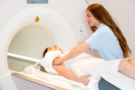 Radiologist preparing scan of shoulder with MRI