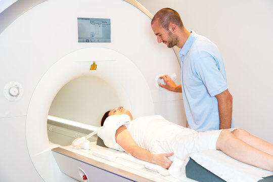 Radiologist preparing scan of shoulder with MRI