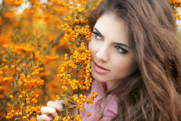 Beautiful young woman portrait, teen girl over autumn yellow par