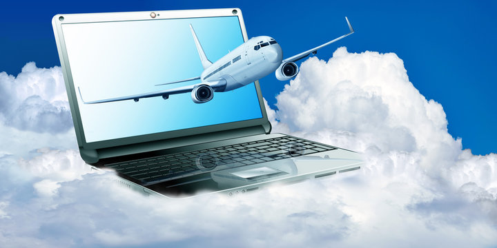 Passagierflugzeug mit Laptop &uuml;ber den Wolken
