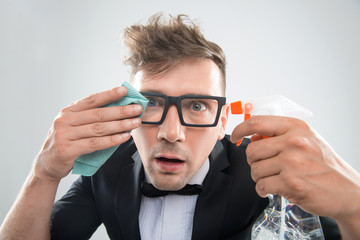 Hipster cleaning his glasses