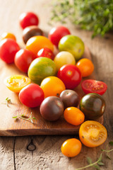 colorful tomatoes over wooden background
