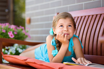 Little girl is reading a book