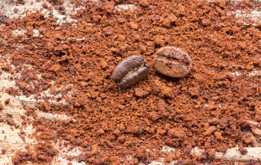ground coffee and grain on wood background