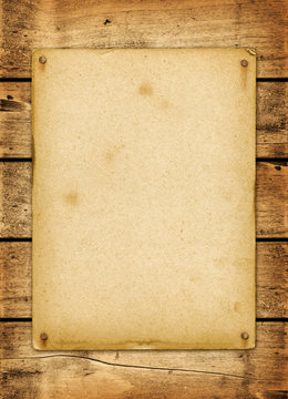 Blank vintage poster nailed on a wood board