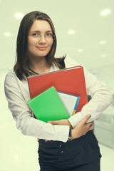 Fototapeta premium Young woman secretary at work at the office