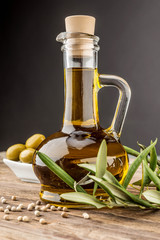 Olive oil  branch wooden table