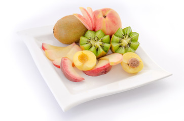 Sliced fruits on plate, close up