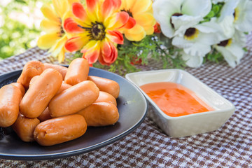 sausages and sauce on table
